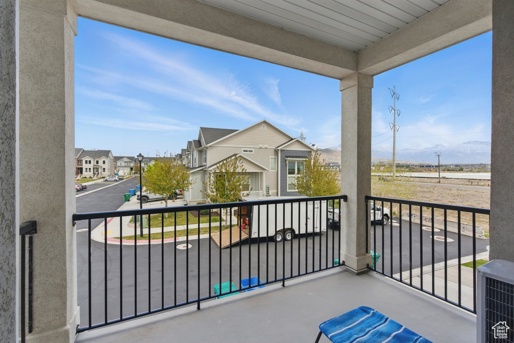 Balcony with central air condition unit and a residential view