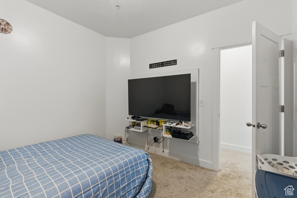 Carpeted bedroom featuring baseboards