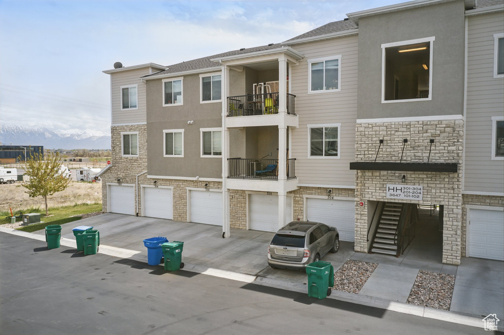 View of building exterior featuring driveway and a garage