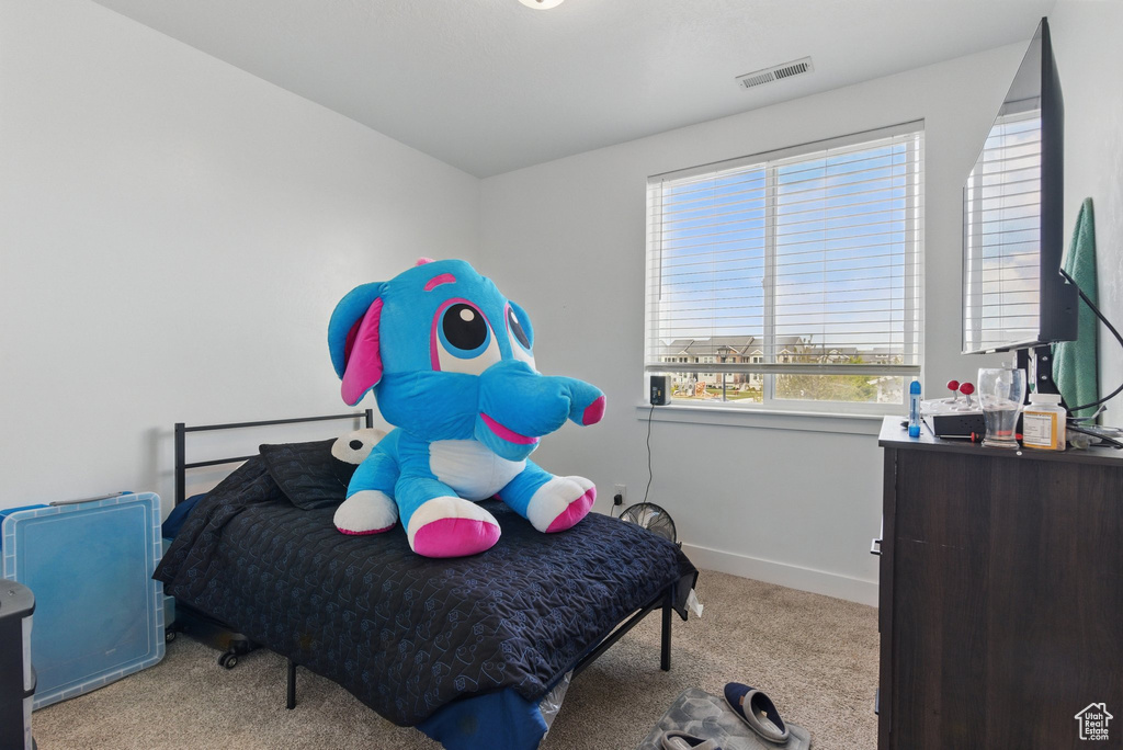 Bedroom featuring visible vents, carpet floors, and baseboards