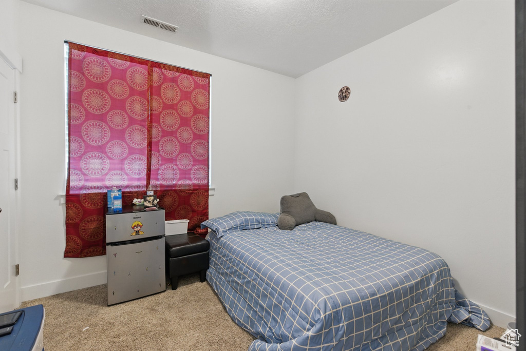 Bedroom featuring visible vents, carpet flooring, and baseboards