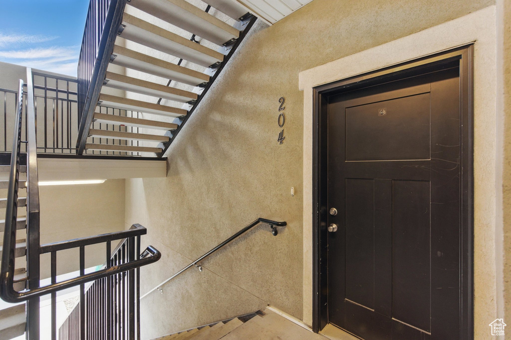 View of exterior entry with a balcony