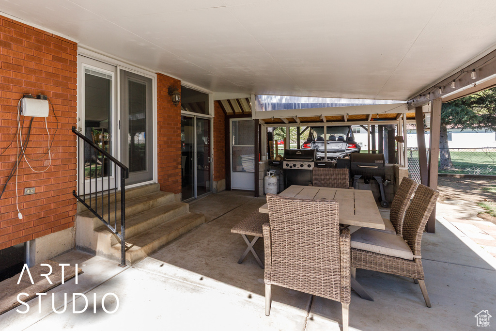 View of patio / terrace featuring entry steps and fence