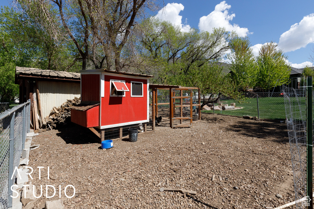 View of poultry coop featuring fence