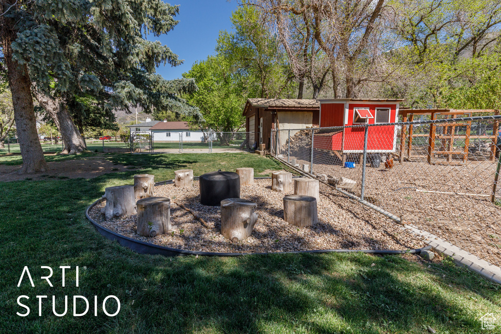 View of yard with an outdoor structure, exterior structure, and fence