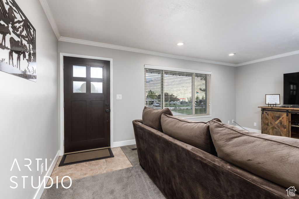 Carpeted living area featuring recessed lighting, baseboards, and ornamental molding