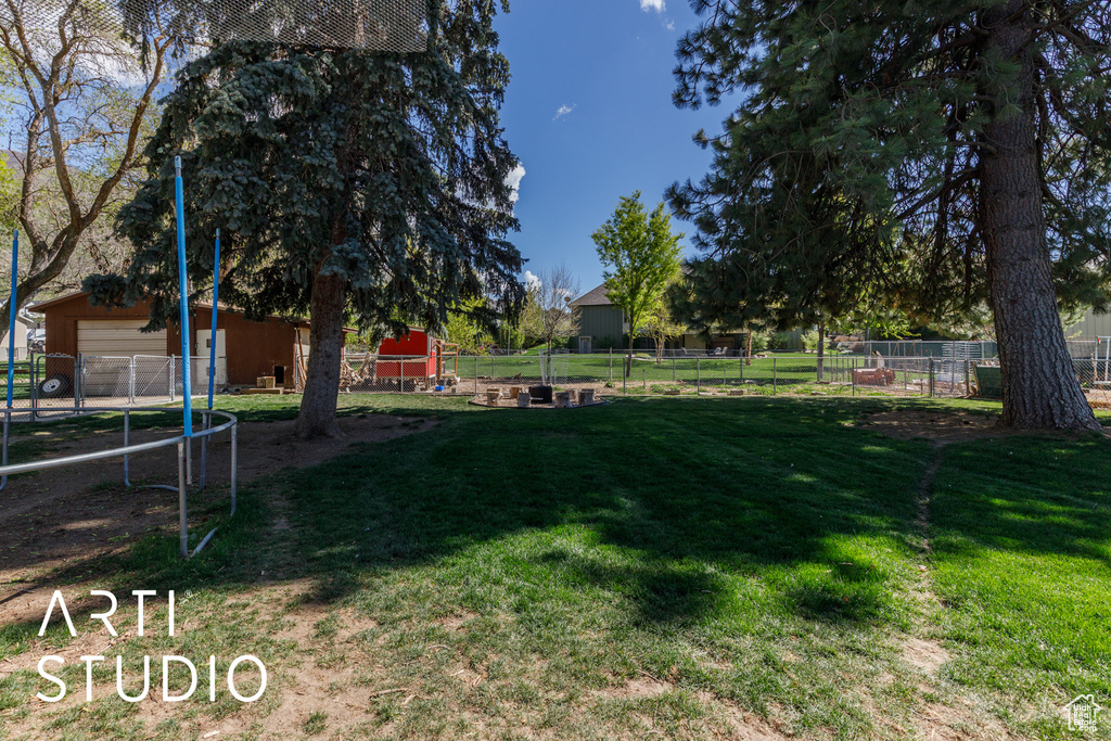 View of yard with fence and a garage