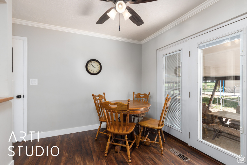 Dining area featuring a ceiling fan, visible vents, crown molding, wood finished floors, and baseboards