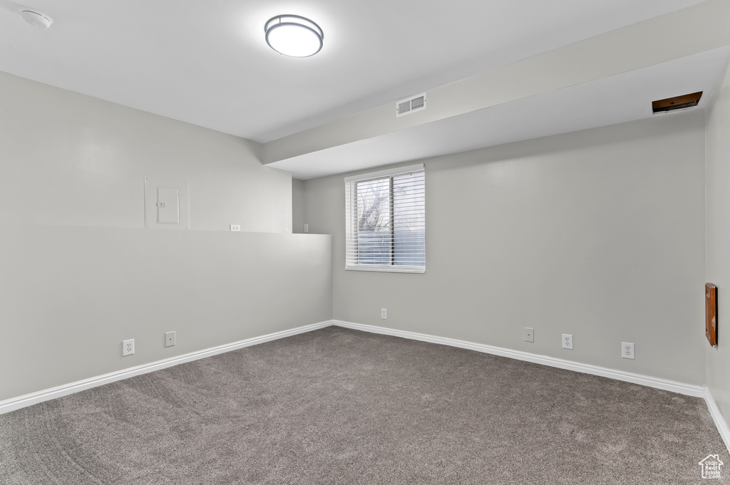 Spare room with baseboards, carpet, and visible vents