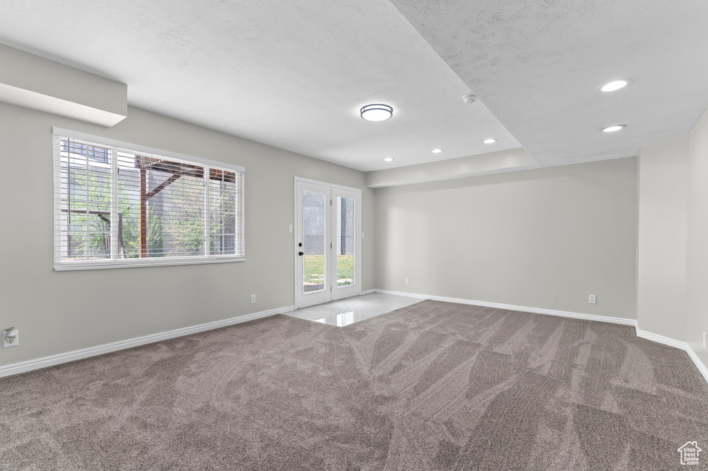 Carpeted spare room with recessed lighting, baseboards, and a textured ceiling