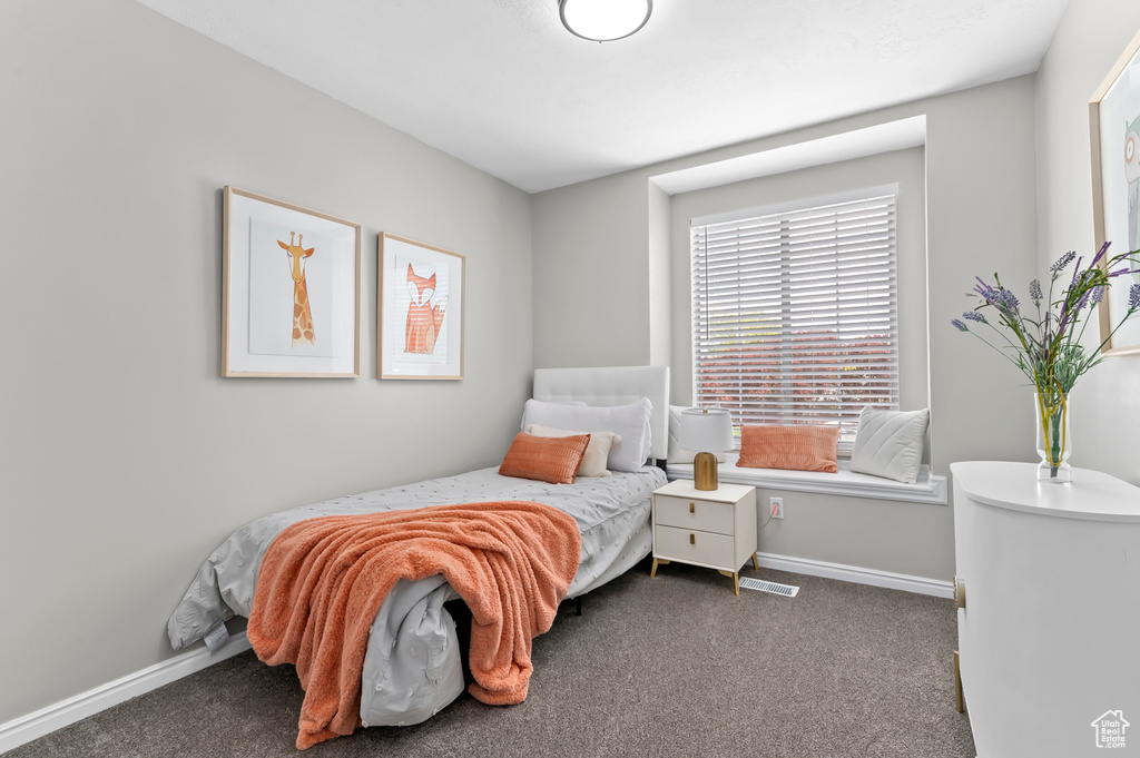 Carpeted bedroom featuring baseboards