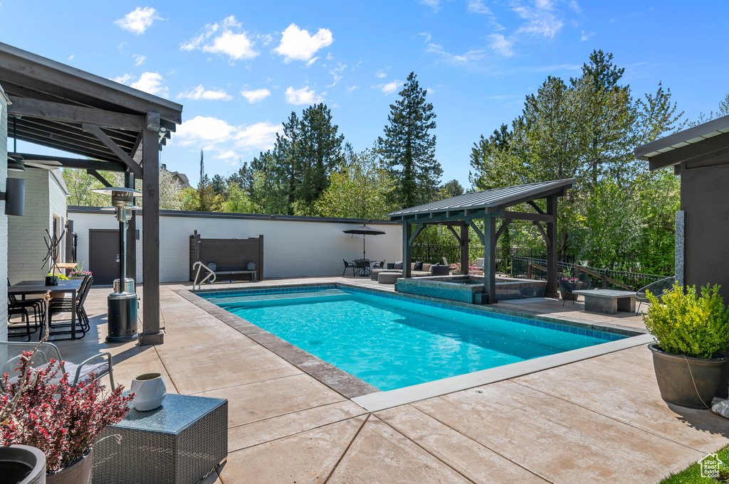 View of swimming pool with a fenced in pool, a patio, and a gazebo