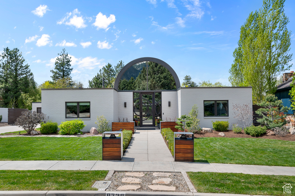 Modern home featuring a front lawn