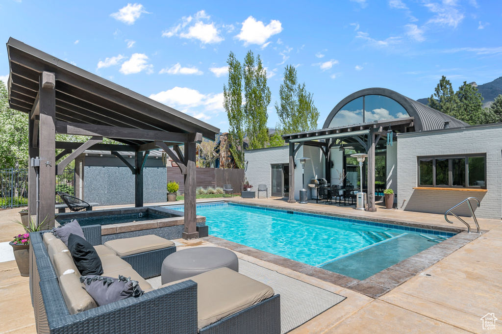 View of swimming pool featuring a fenced in pool, a patio area, fence, and a gazebo