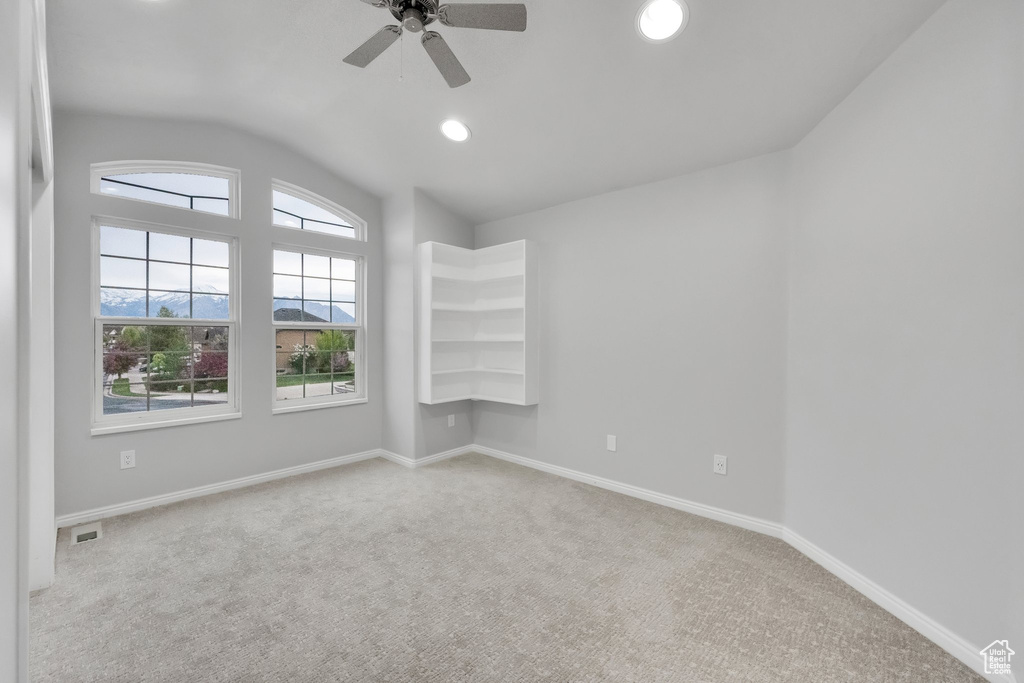 Empty room with visible vents, recessed lighting, a ceiling fan, carpet, and vaulted ceiling