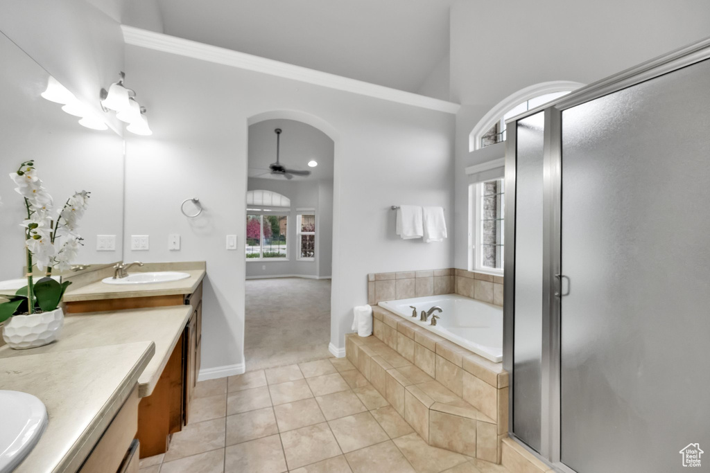 Bathroom with ceiling fan, a garden tub, tile patterned flooring, a shower stall, and vanity