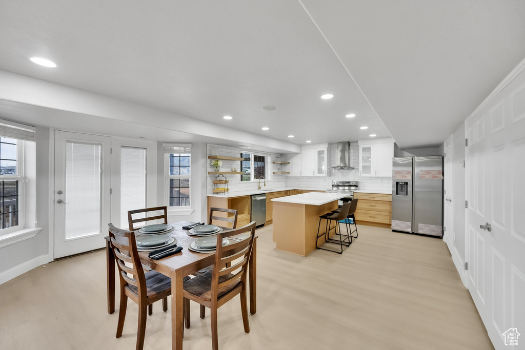 Dining space featuring recessed lighting, baseboards, a healthy amount of sunlight, and light wood-type flooring