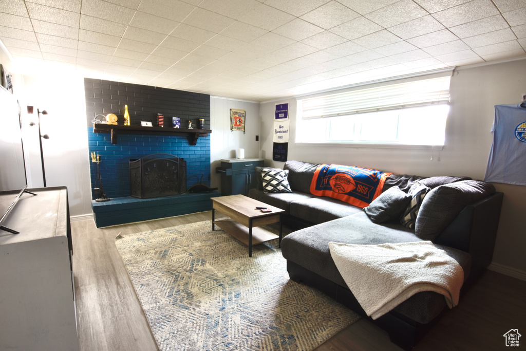 Living area with wood finished floors and a brick fireplace