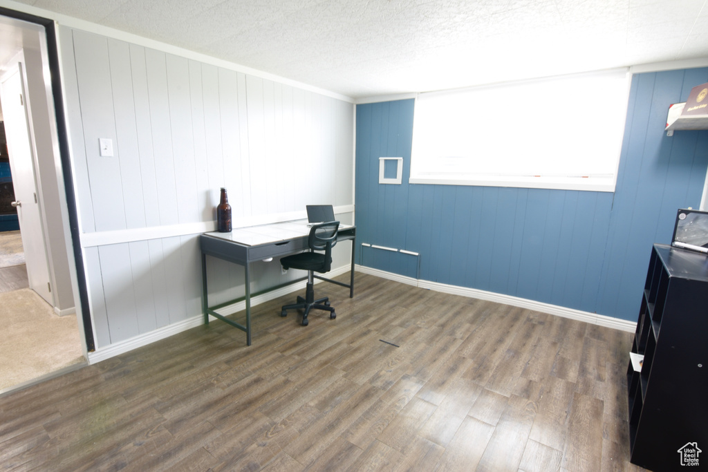 Office featuring baseboards, wood finished floors, and ornamental molding