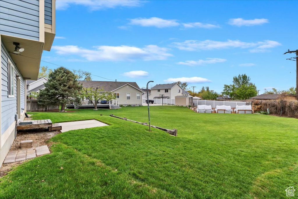 View of yard featuring an outdoor living space, fence, and a patio