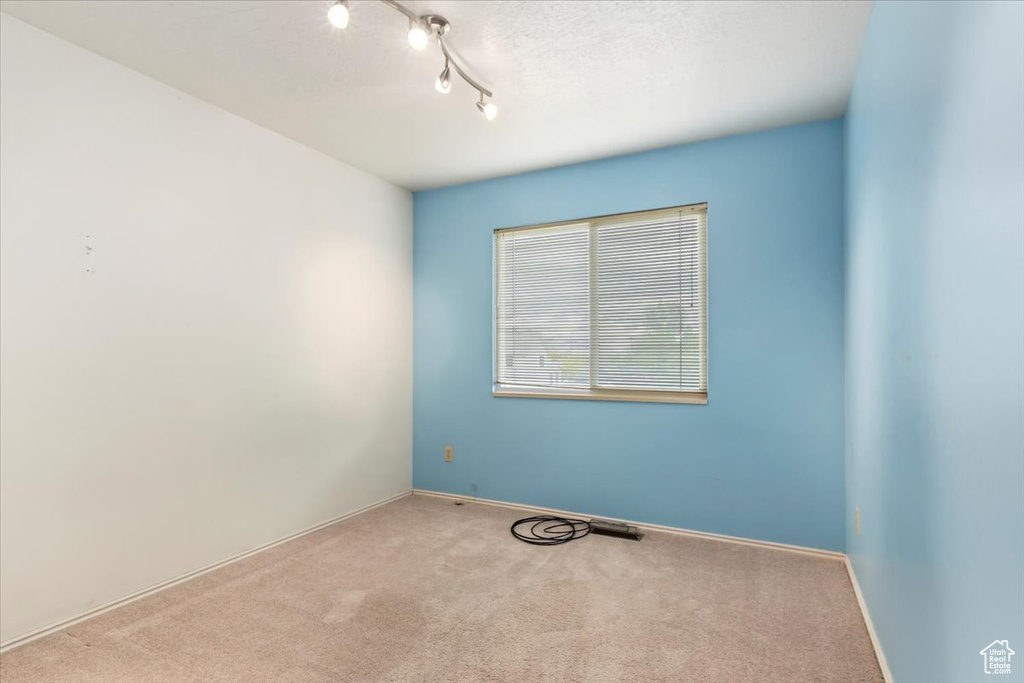 Spare room with baseboards and carpet flooring