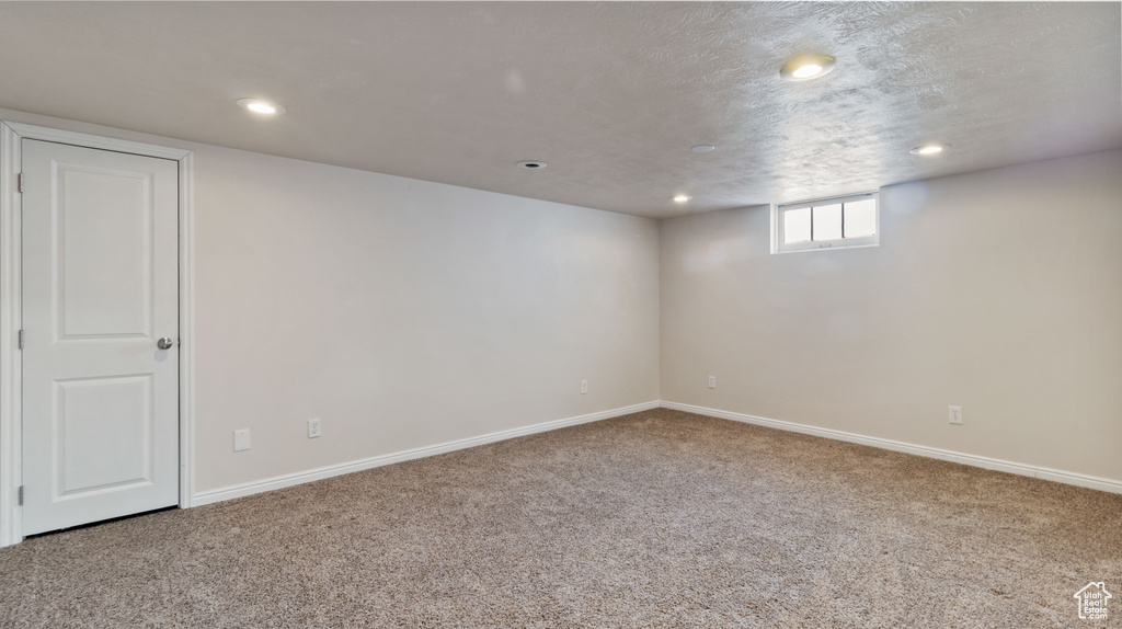 Basement featuring carpet floors, baseboards, and recessed lighting