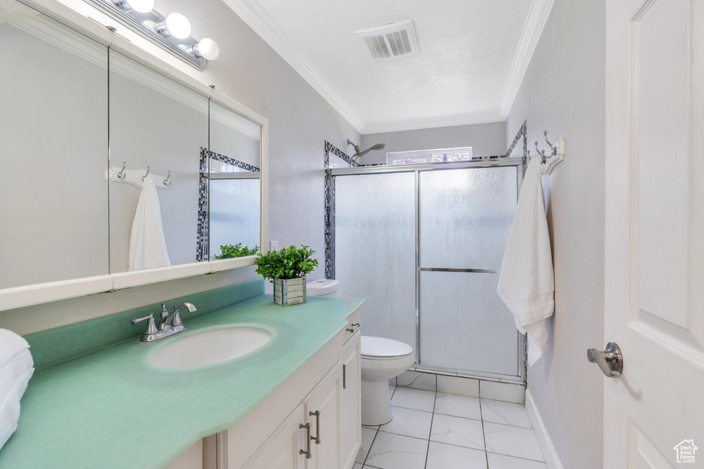Bathroom with ornamental molding, a stall shower, and visible vents