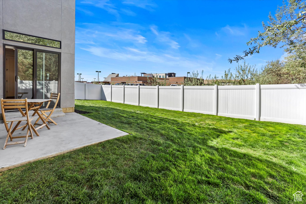 View of yard with a patio and a fenced backyard