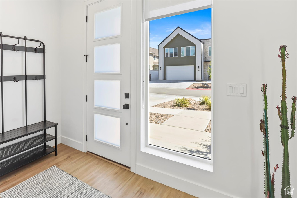 Entryway featuring baseboards and wood finished floors