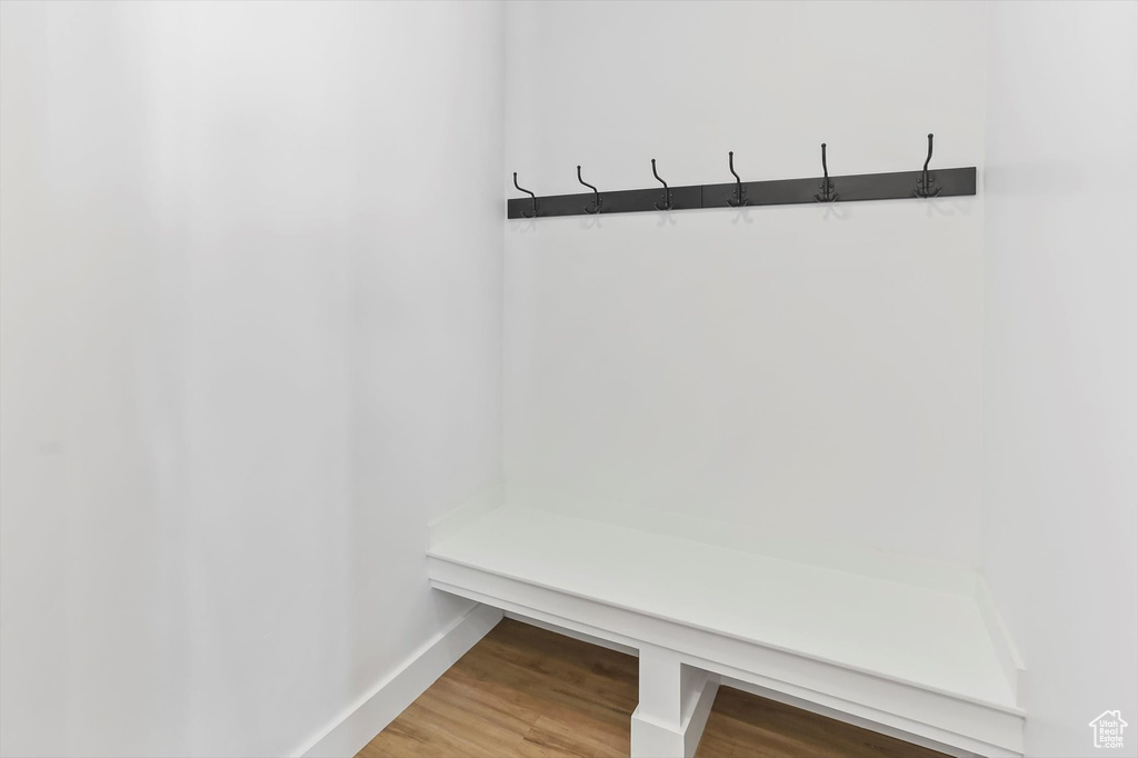 Mudroom featuring light wood-style floors and baseboards