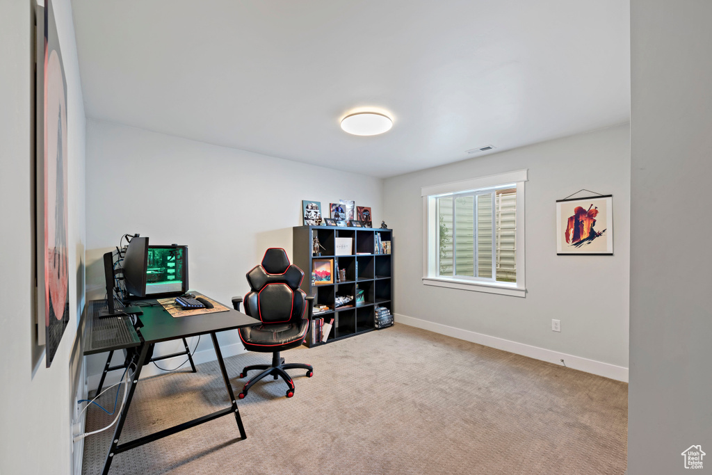 Carpeted office space with baseboards and visible vents
