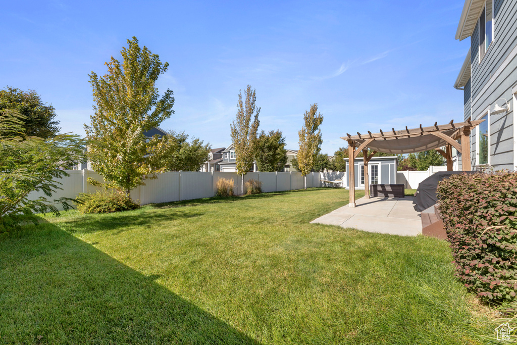 View of yard featuring a fenced backyard, a patio area, and a pergola