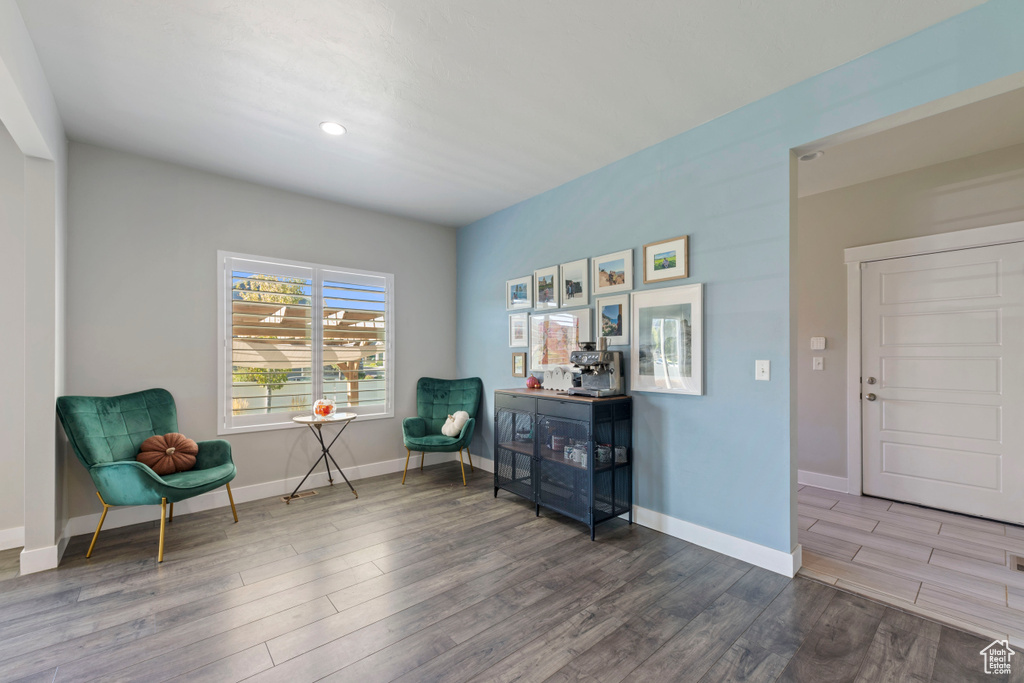Sitting room featuring baseboards, recessed lighting, and wood finished floors