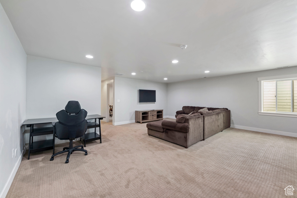Living area featuring baseboards, carpet, and recessed lighting
