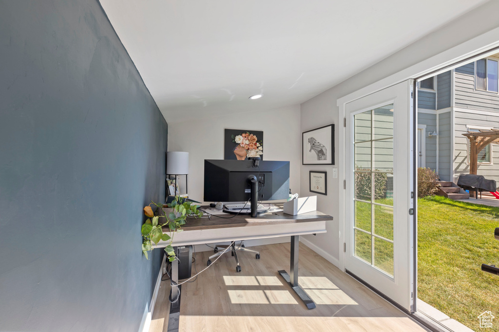 Office area with baseboards, vaulted ceiling, a wealth of natural light, and wood finished floors