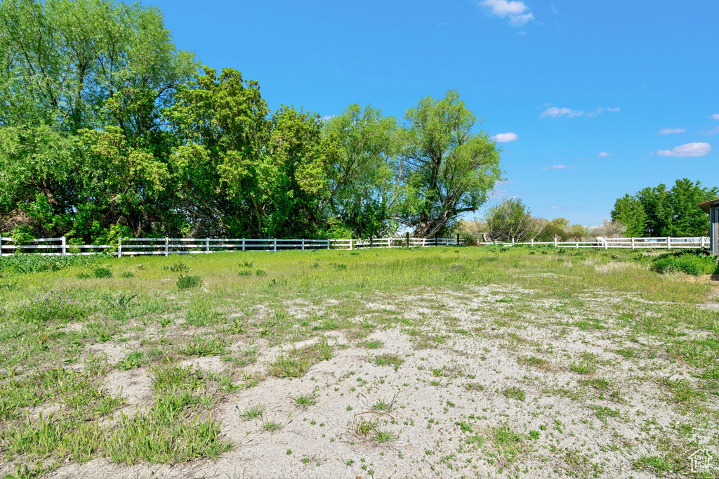 View of yard featuring fence and a rural view
