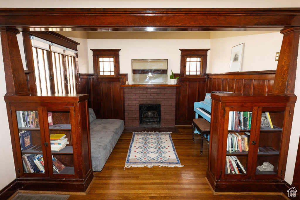 Living area featuring wainscoting, wood finished floors, and a wealth of natural light