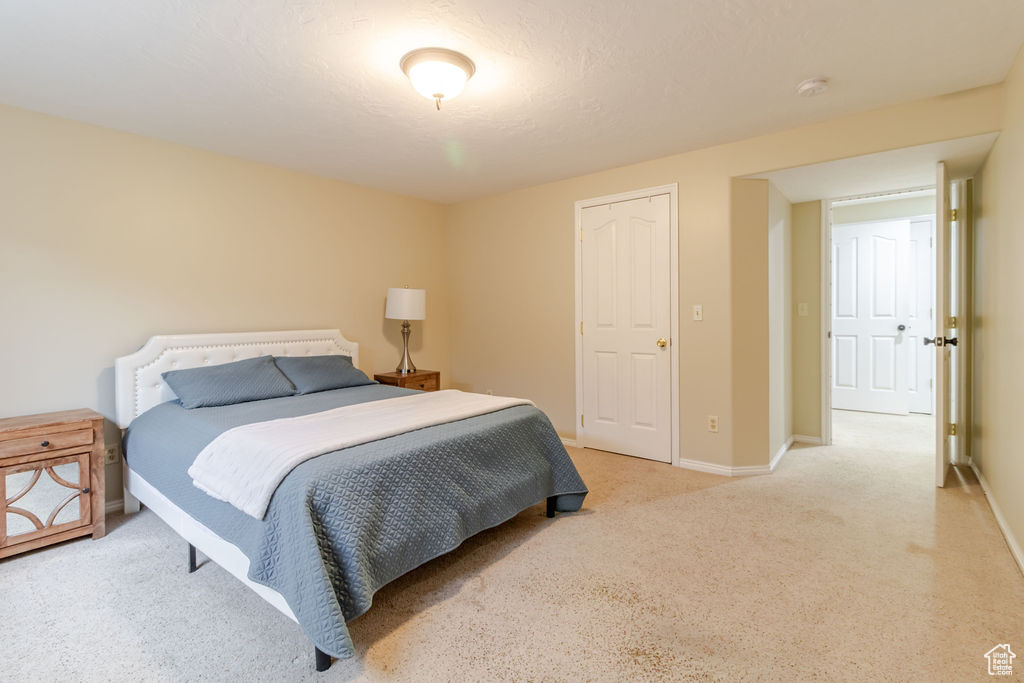 Carpeted bedroom with baseboards