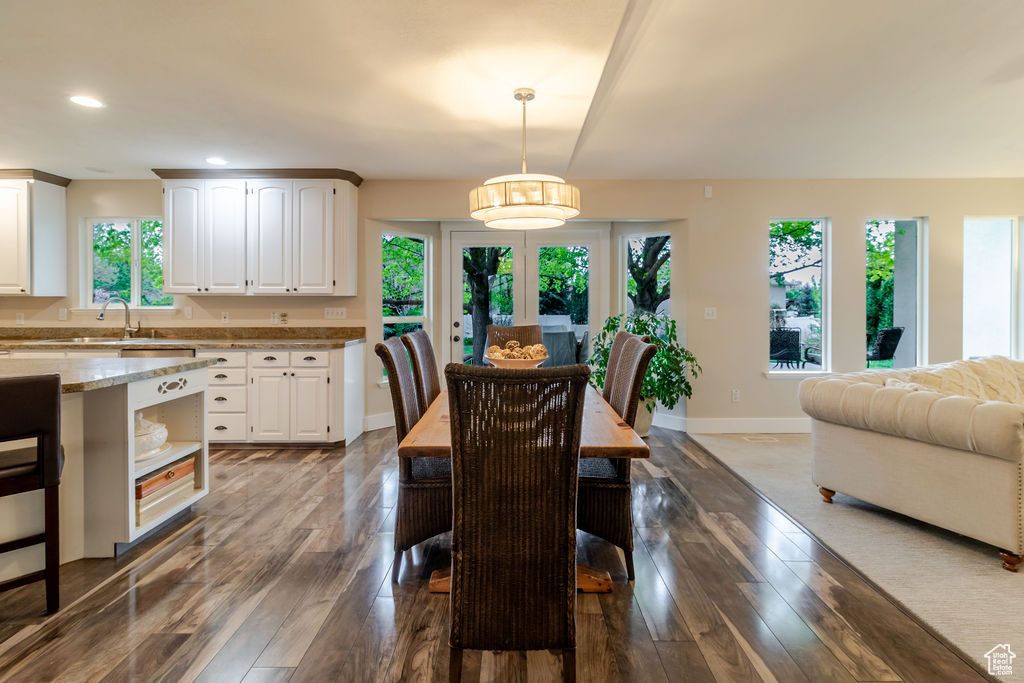 Dining area with recessed lighting, baseboards, and dark wood finished floors