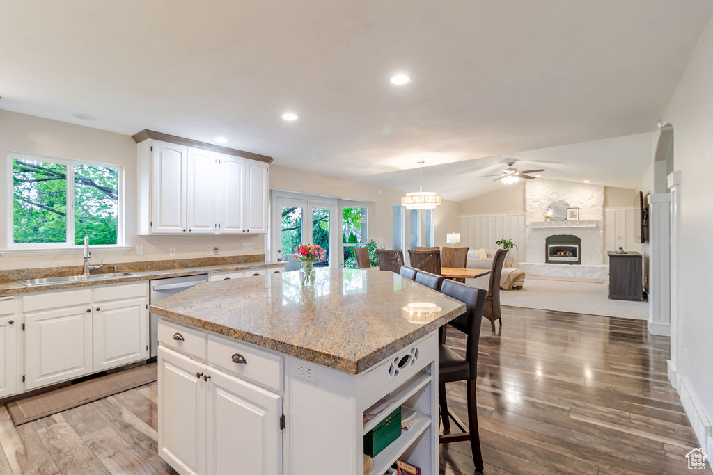 Kitchen with a sink, ceiling fan, a center island, light wood-type flooring, and dishwasher