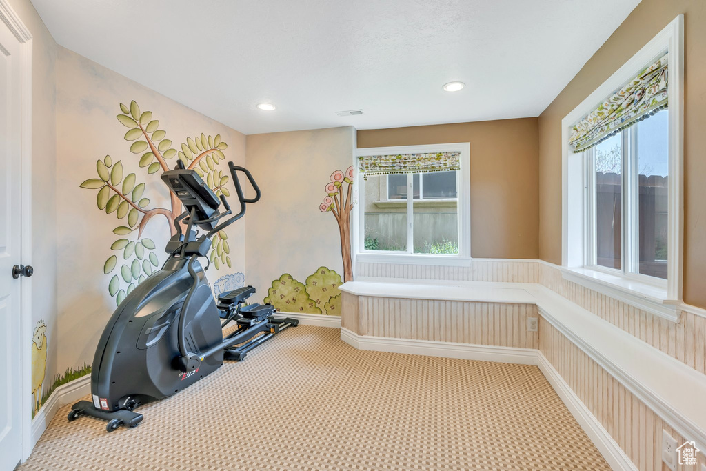 Exercise room with recessed lighting, a healthy amount of sunlight, and carpet