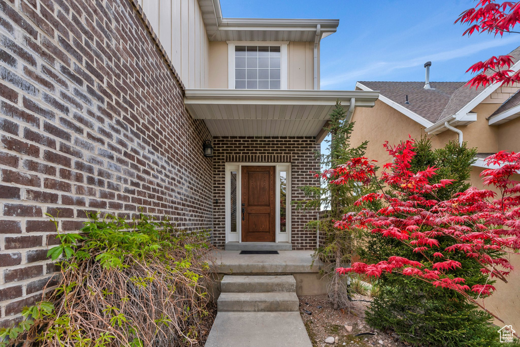 Entrance to property featuring brick siding
