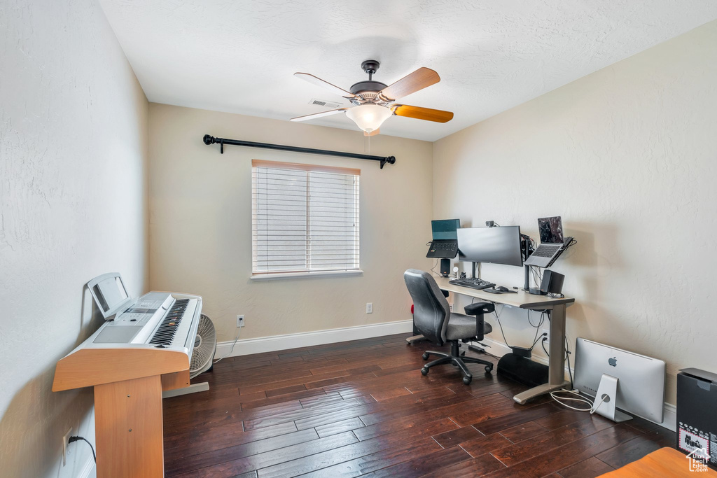 Office area featuring baseboards, ceiling fan, and hardwood / wood-style floors