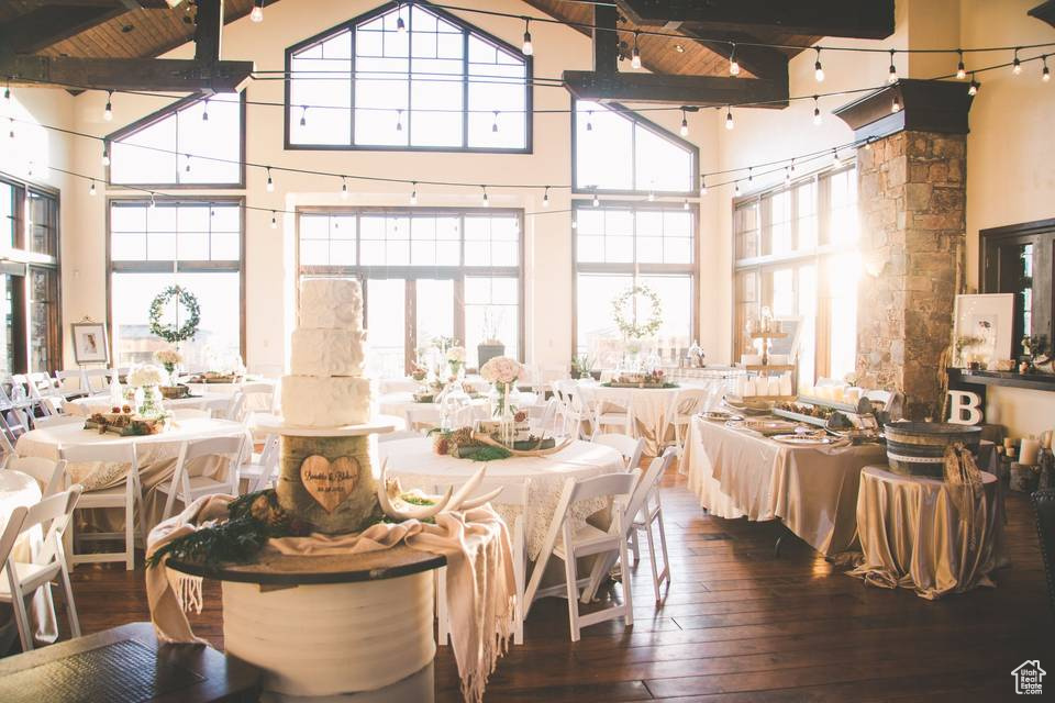 Dining space featuring high vaulted ceiling, beamed ceiling, and hardwood / wood-style flooring
