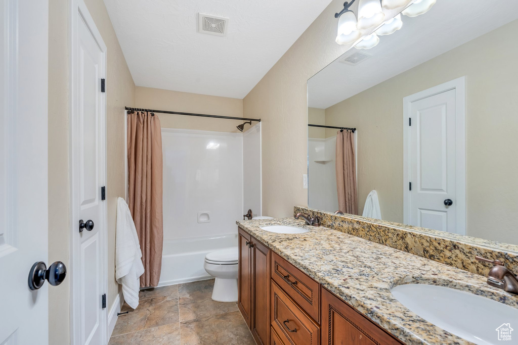 Full bath featuring visible vents, a sink, and double vanity