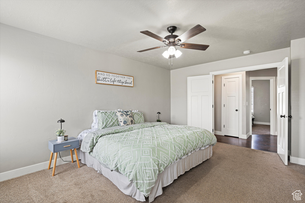 Bedroom with carpet flooring, baseboards, and ceiling fan