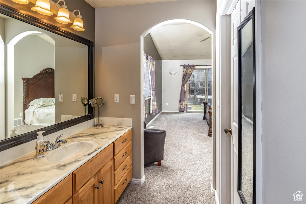 Bathroom with baseboards, visible vents, ensuite bathroom, and vanity