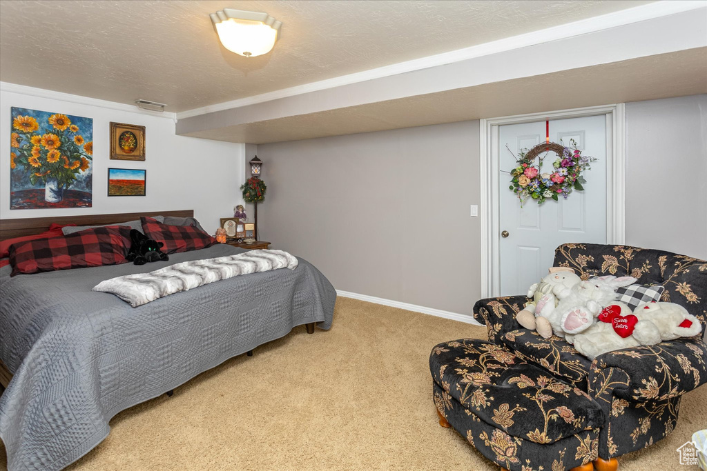 Carpeted bedroom featuring baseboards