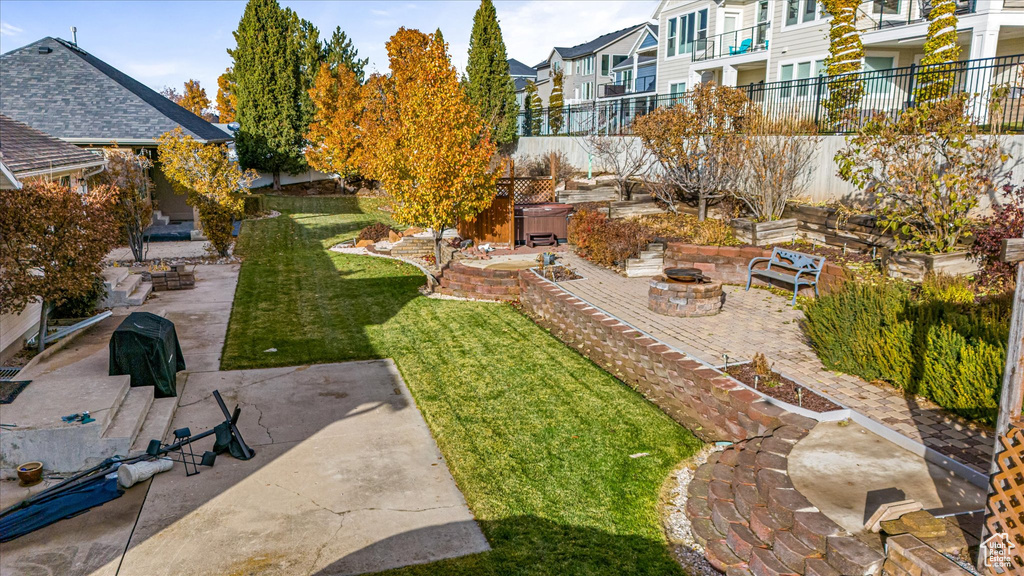 View of yard featuring a residential view, a patio, and an outdoor fire pit