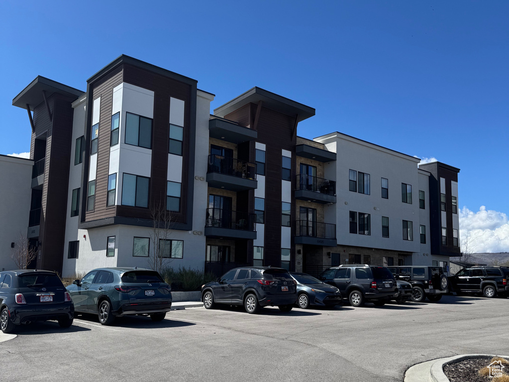 View of property with uncovered parking
